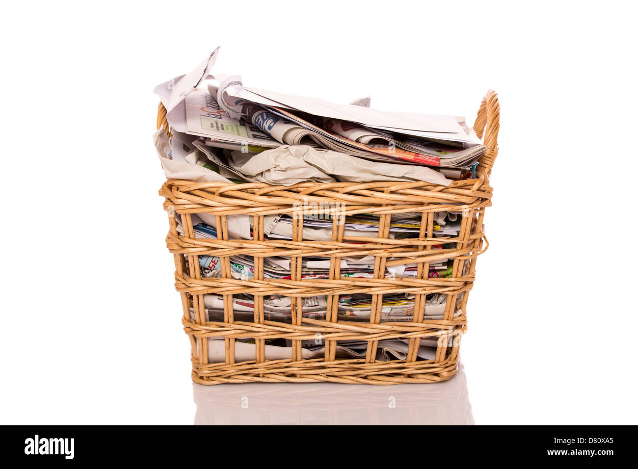 Full wastepaper basket isolated on white background Stock Photo