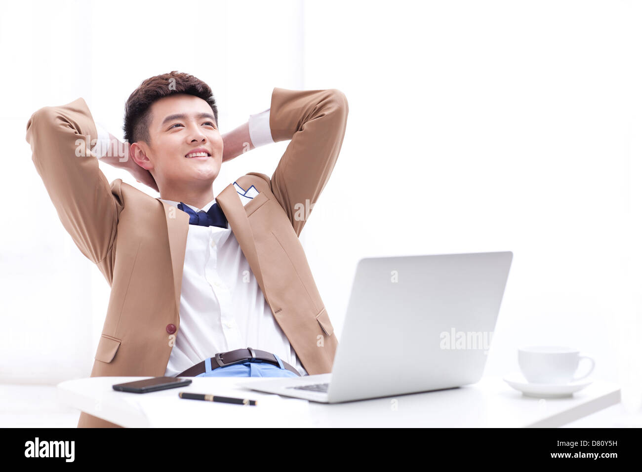 Stylish young businessman taking a break in office Stock Photo