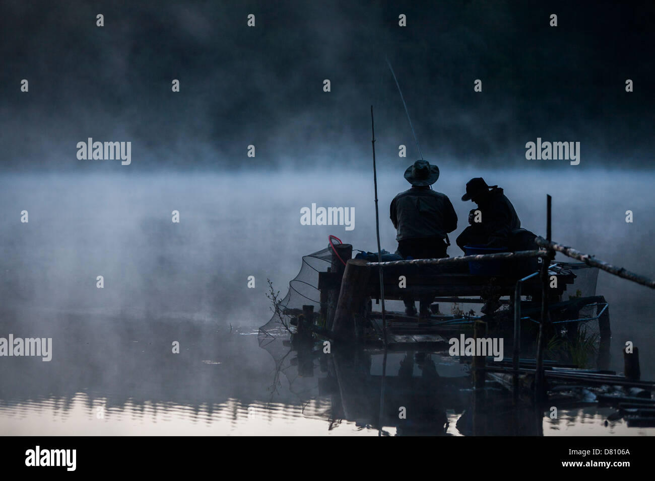 Men fishing on the lake in early morning.  Poland, Europe 2011 Stock Photo