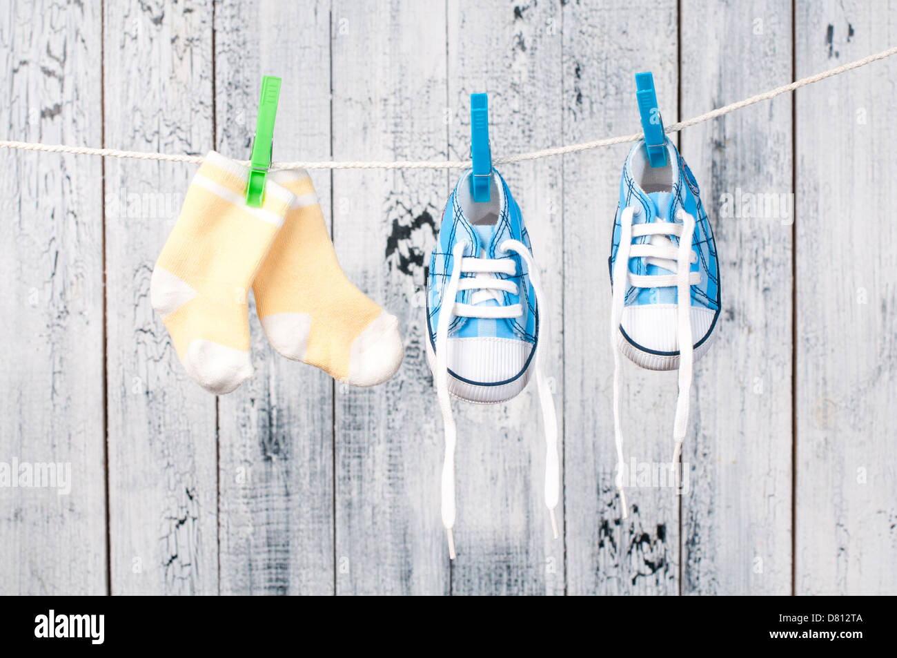 Baby clothes hanging on the clothesline. Stock Photo