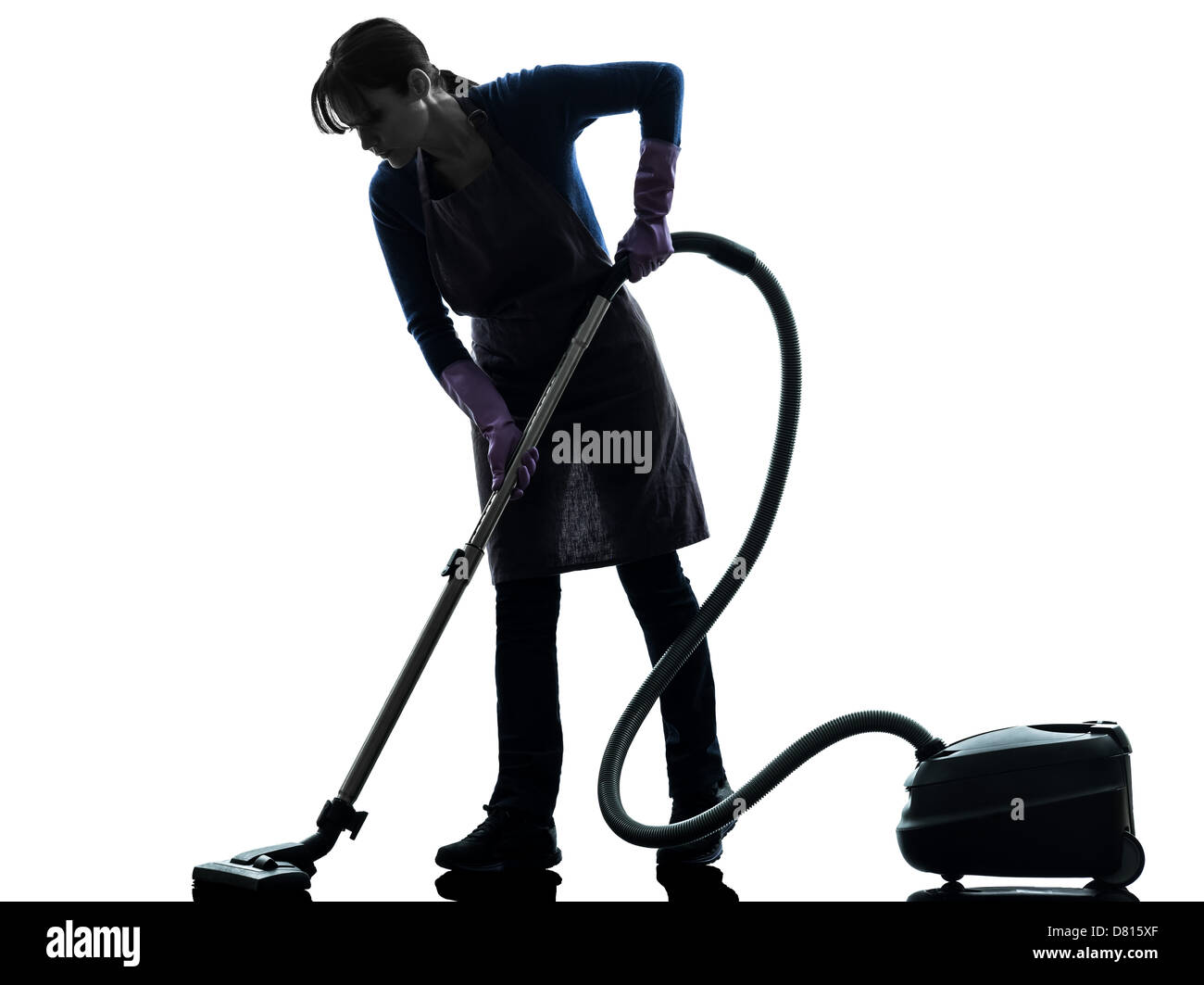 one  woman maid Vacuum Cleaner cleaning in silhouette studio isolated on white background Stock Photo