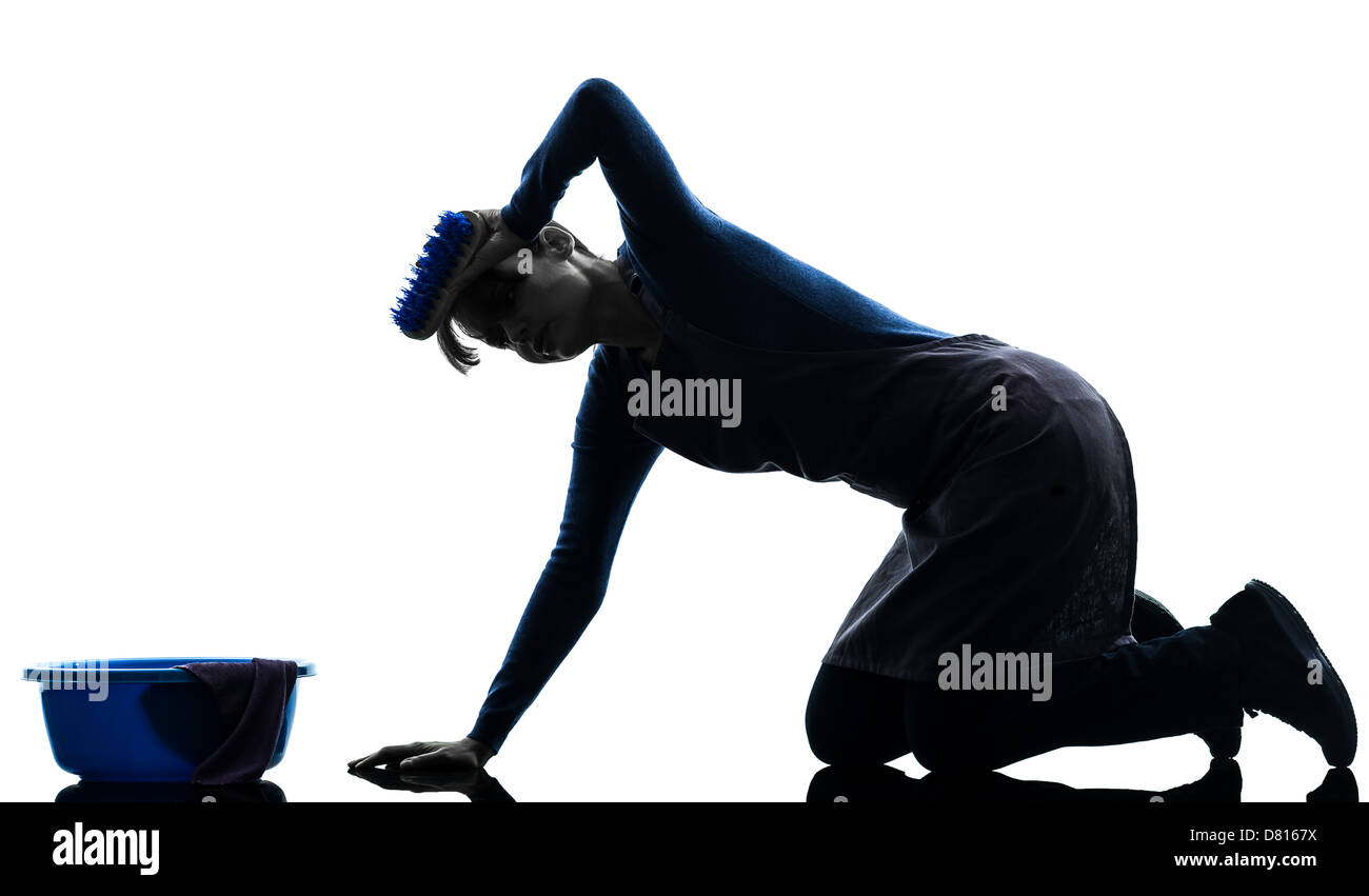 one  woman maid cleaning washing floor in silhouette studio isolated on white background Stock Photo