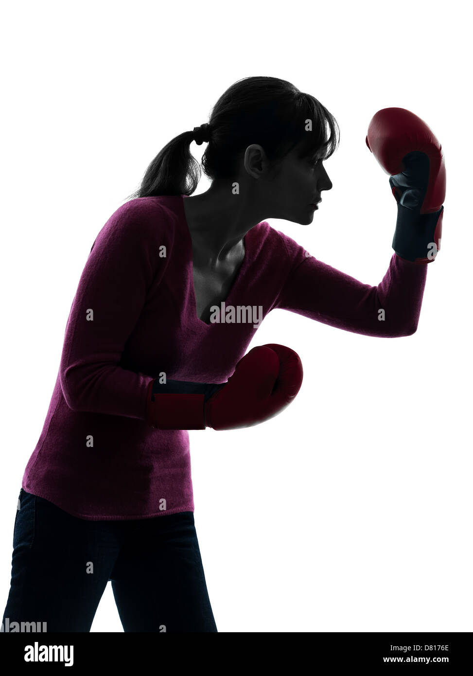 one  woman with boxing gloves in silhouette studio isolated on white background Stock Photo