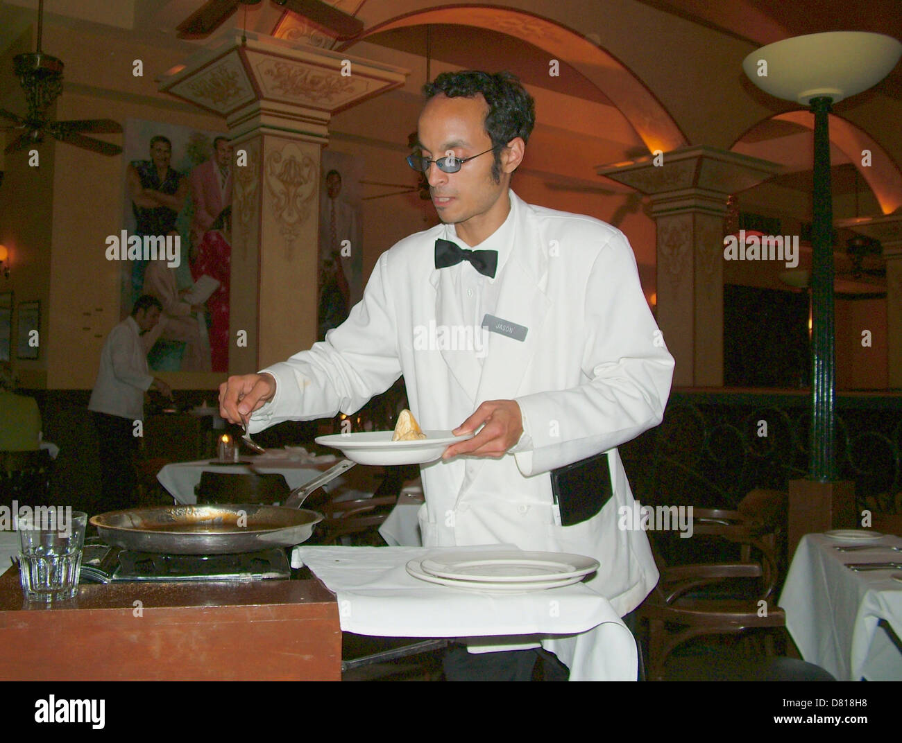 Waiter cooks a Banana flambe at Dickie Brennan s Palace Cafe Canal