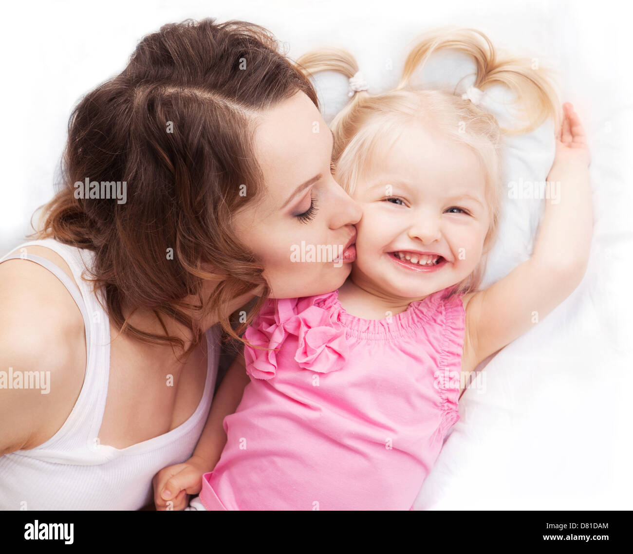 young mother and her baby in bed at home Stock Photo Alamy