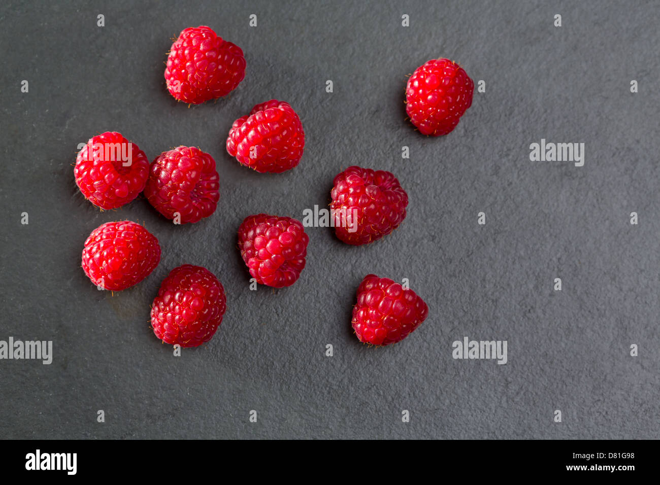 berries raspberry on black slate background macro closeup Stock Photo