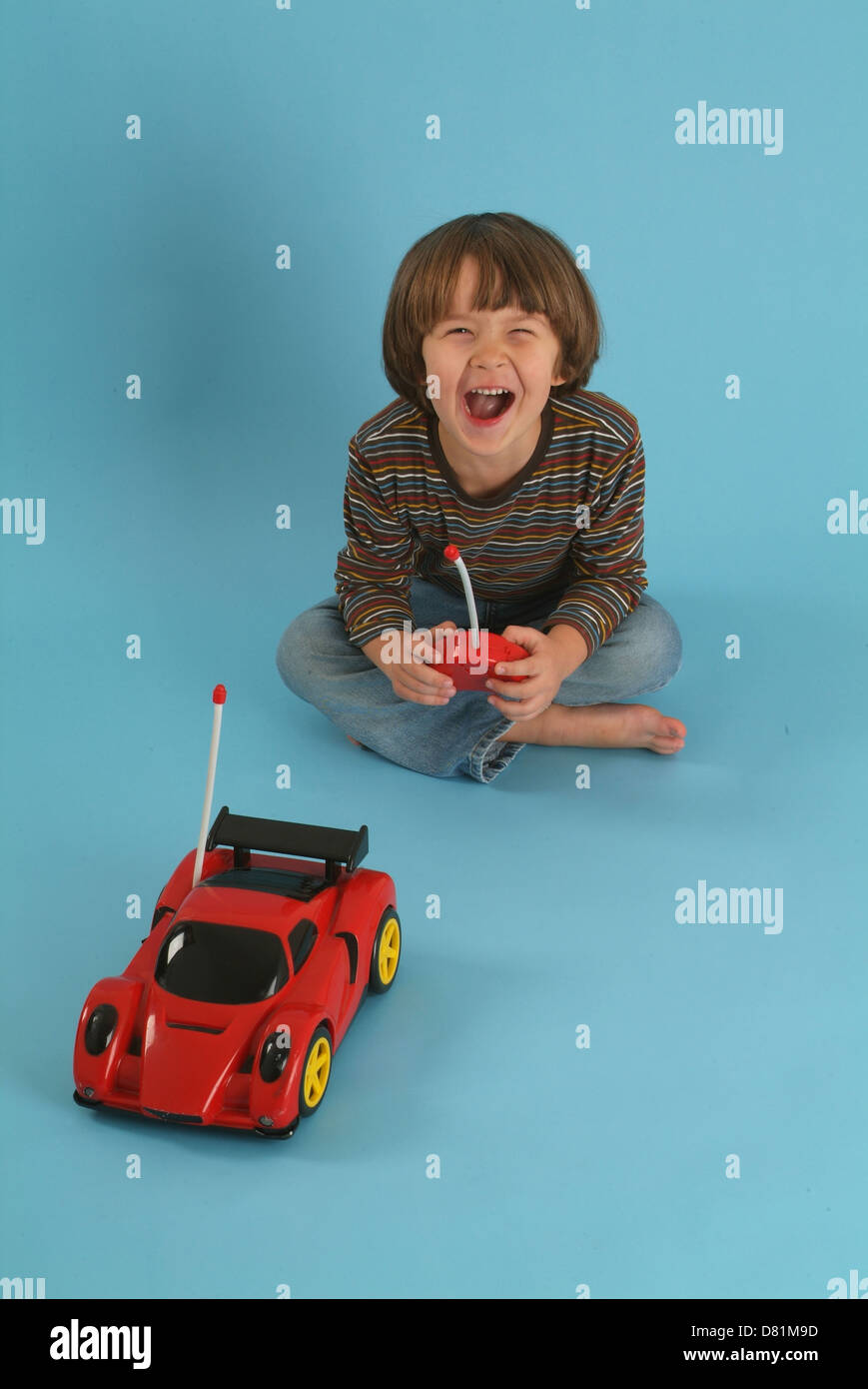 Child playing with a remote controlled toy car Stock Photo Alamy