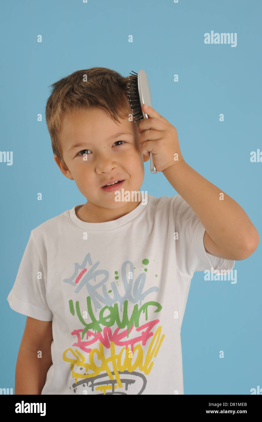 Boy brushing his hair Stock Photo