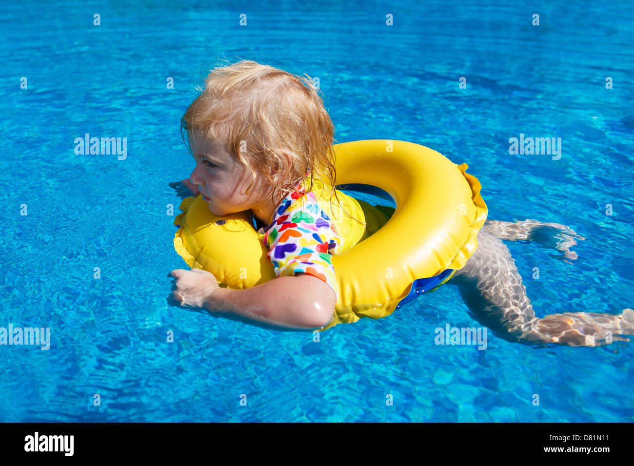 Little baby swimming in a pool on swimming ring Stock Photo - Alamy