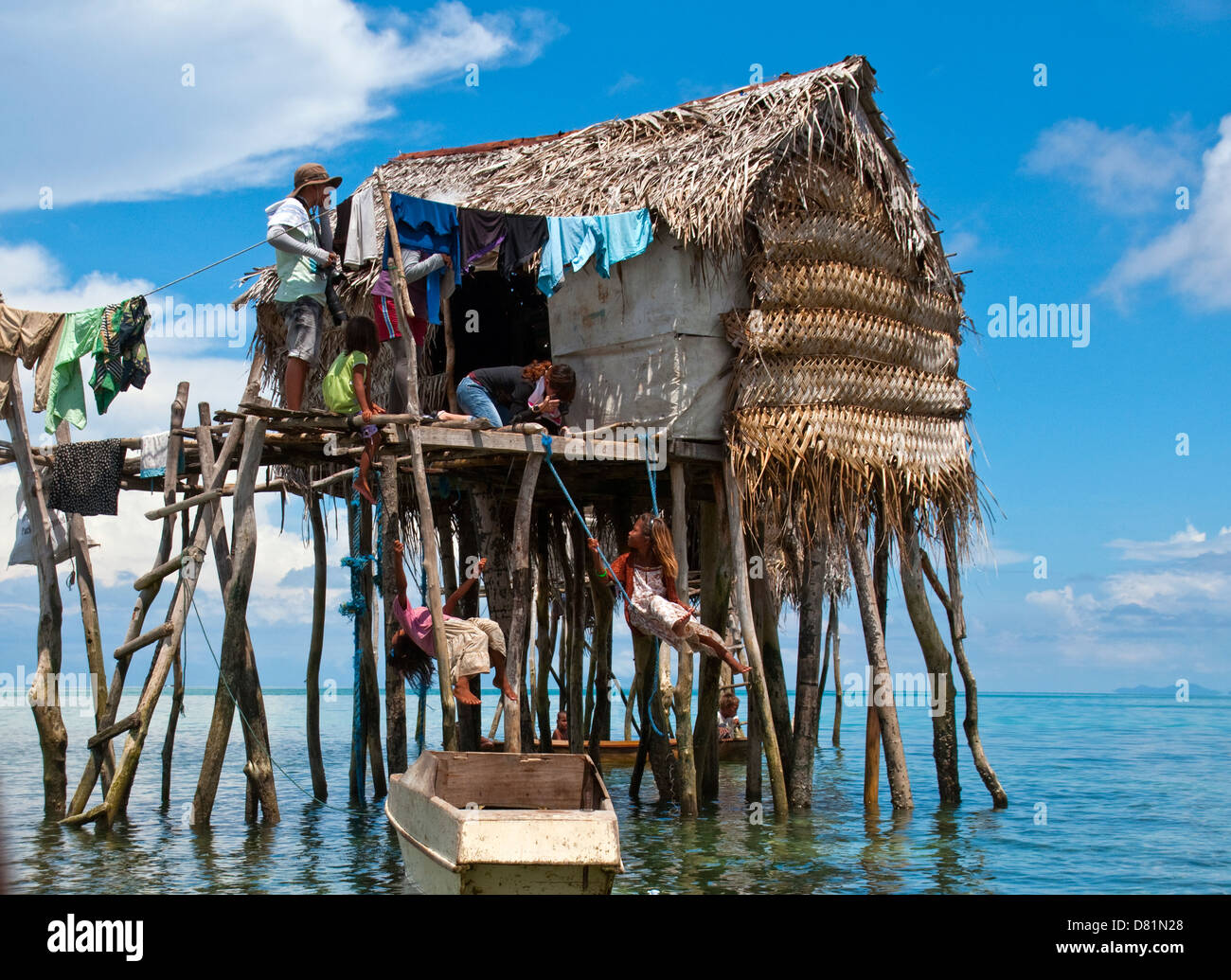 2 kids swinging under the floating hut Stock Photo - Alamy