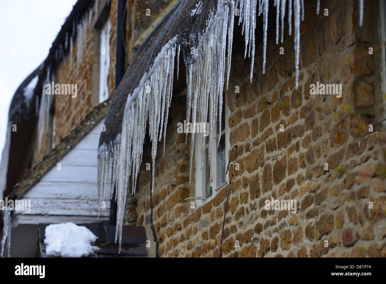 Icicles Hanging From Roof Of Thatched Cottage In The North Stock