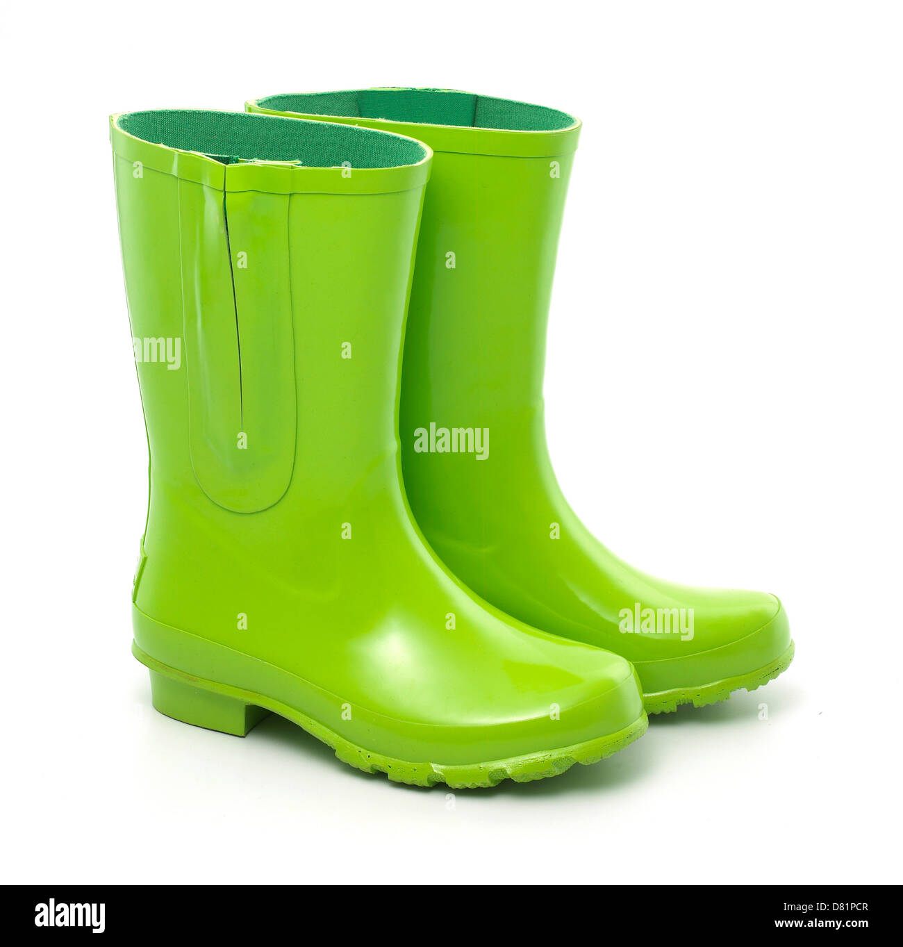 pair of bright green wellies cut out against a white background Stock Photo
