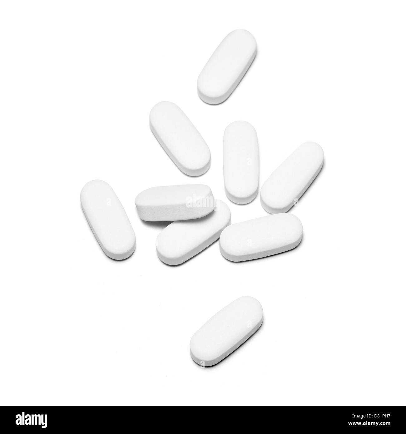 Group of white pills cut out white background Stock Photo