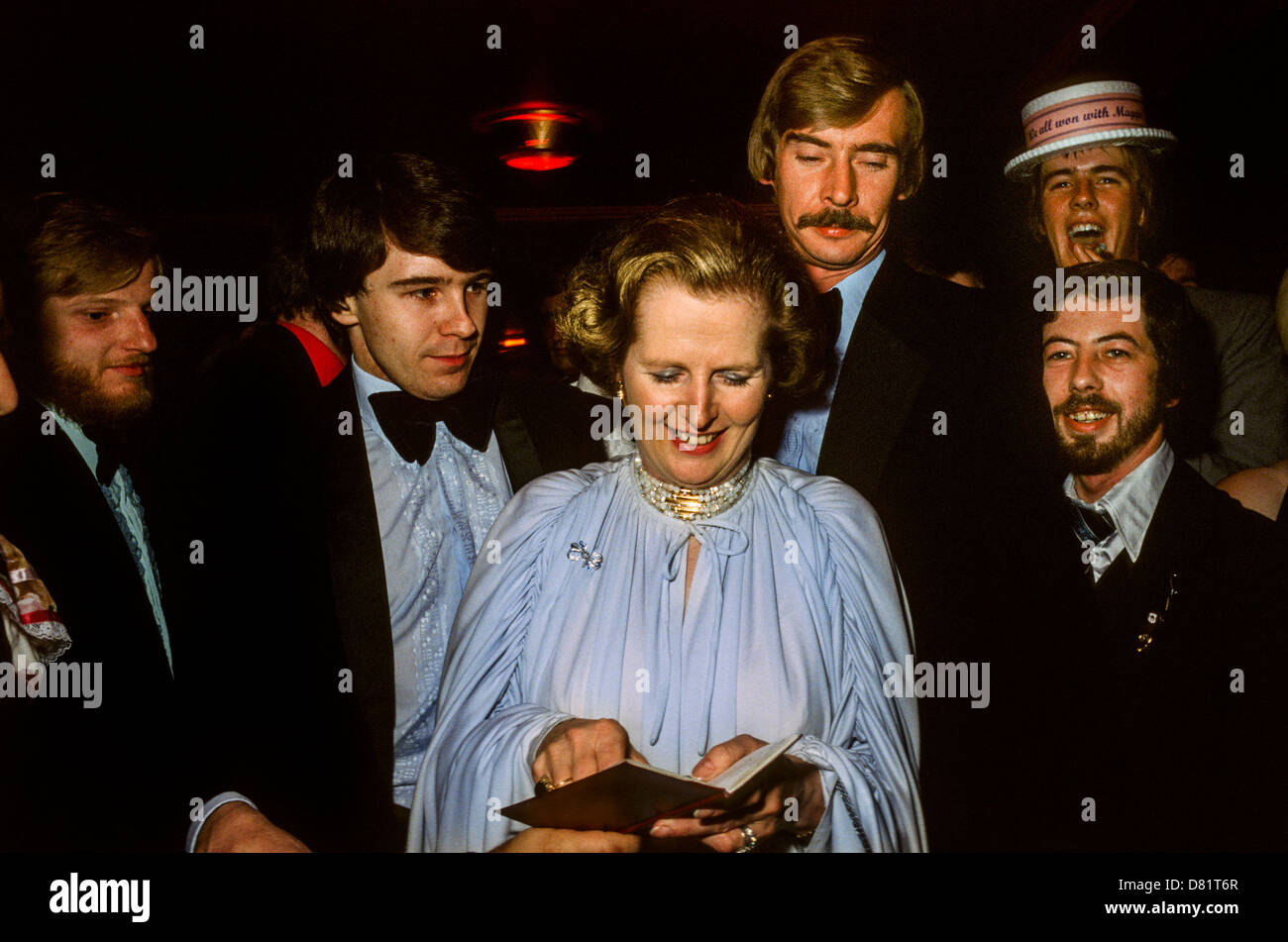 Margaret Thatcher accompanied by protection detectives signing autographs at the 1979 Conservative Party Conference Ball. Stock Photo