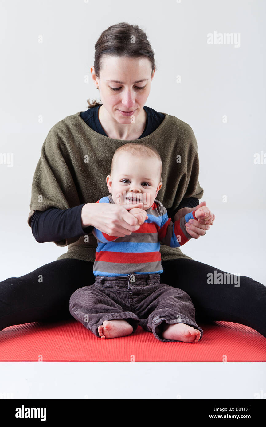 mother and baby practicing yoga Stock Photo
