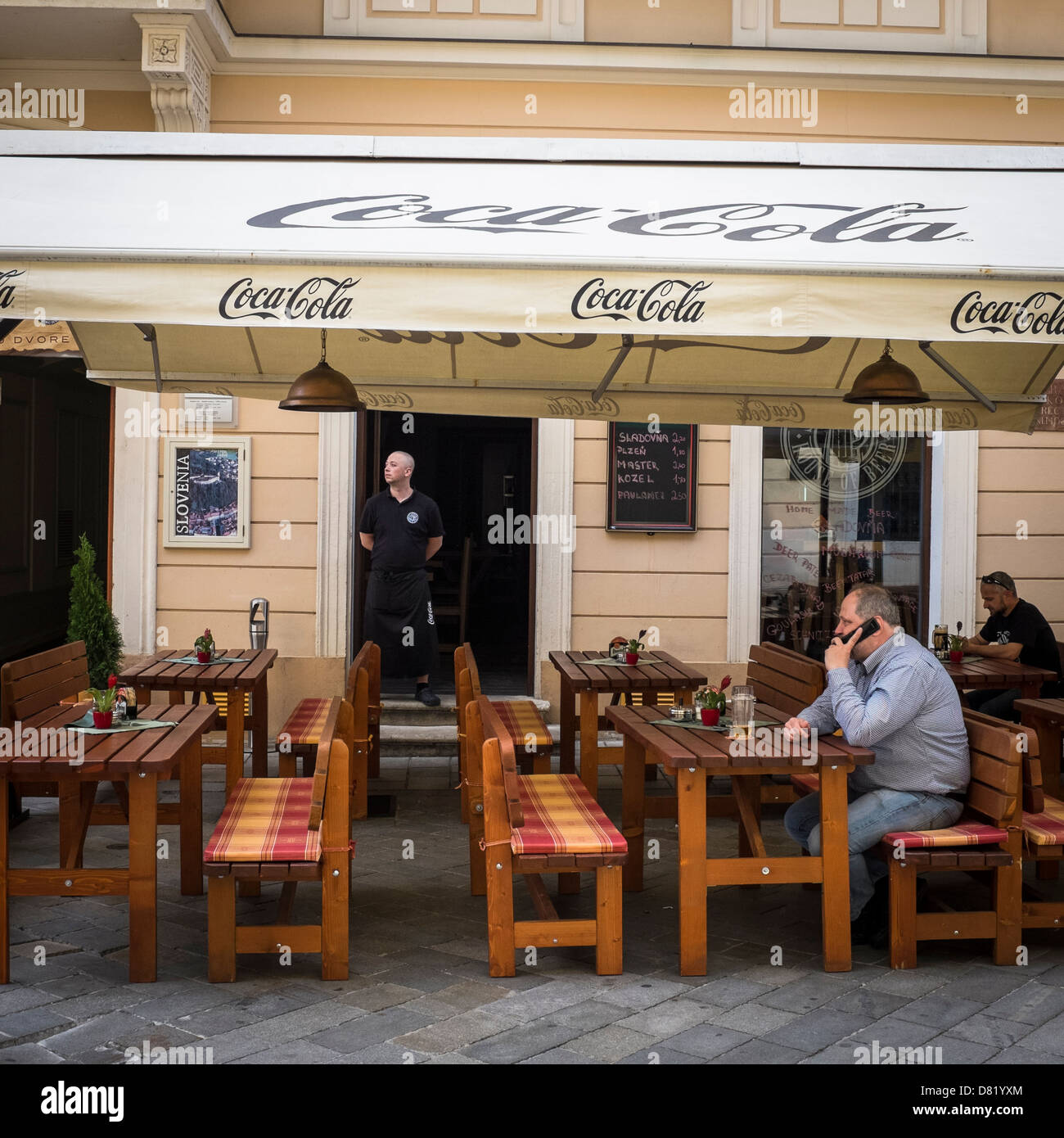 Man with a moblile phone in a pub, Bratislava Stock Photo