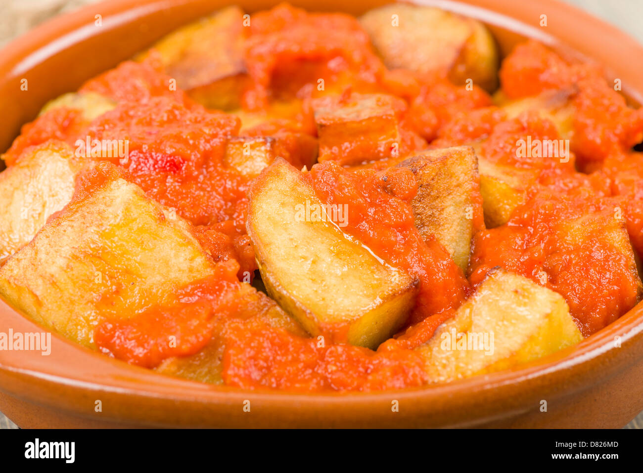 Patatas Bravas - Crispy potato chunks in spicy tomato sauce. Traditional Spanish tapas dish. Stock Photo