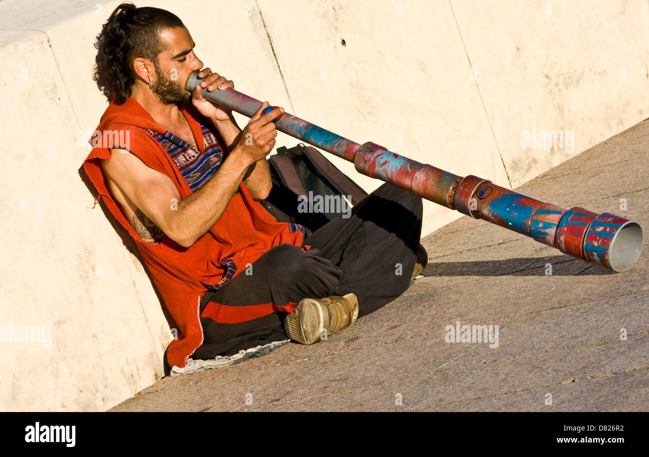 Busker playing a didgeridoo on the Roman Bridge (Puente Romano) Cordoba Spain Andalusia Europe Stock Photo