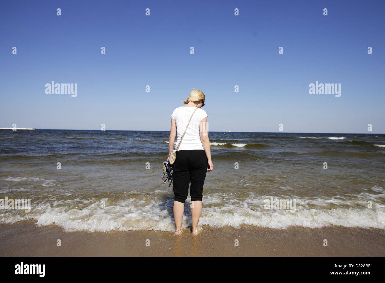 Sopot, Poland 17th, May 2013 Due the very high temperatures over 30 Celsius degrees many tourists and Sopot citizens walks on the Baltic Sea beach, tanning and few very brave swim in the cold Baltic water. Credit:  Michal Fludra / Alamy Live News Stock Photo