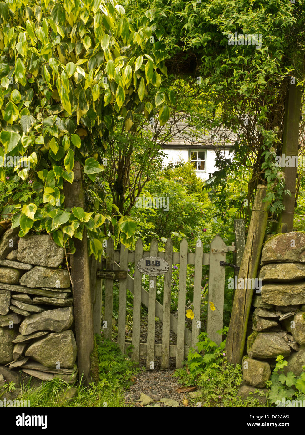 Gate at dry stone wall fence of the Charming Bed and Breakfast hotel at Stonewaite in Lake District, Cumbria, UK Stock Photo