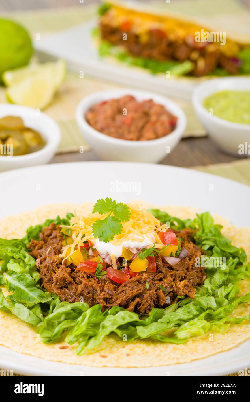 Beef Tacos Mexican shredded beef tacos in soft corn tortillas served with lettuce, sour cream