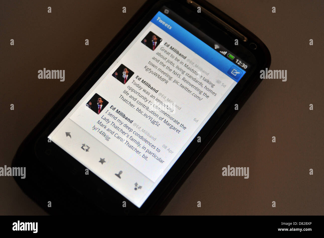 Tweets displayed on a mobile phone screen following the death and funeral of former British Prime Minister Margaret Thatcher. Stock Photo