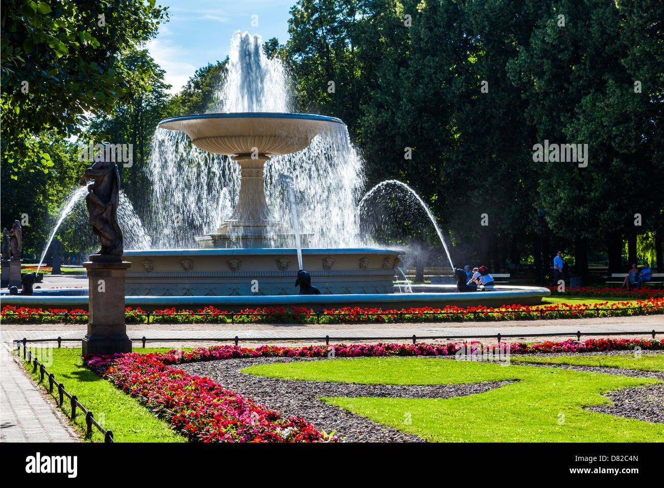 Flower beds, statues and the fountain in Ogród Saski, Saxon Garden, the oldest public park in Warsaw, Poland. Stock Photo