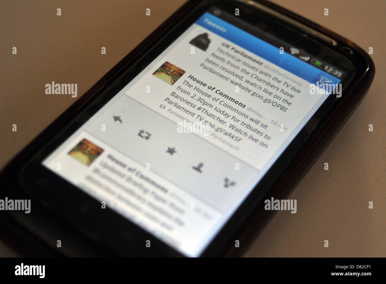 Tweets displayed on a mobile phone screen following the death and funeral of former British Prime Minister Margaret Thatcher. Stock Photo