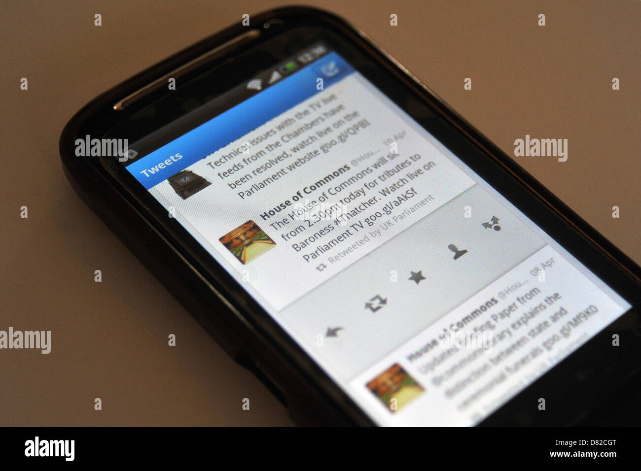 Tweets displayed on a mobile phone screen following the death and funeral of former British Prime Minister Margaret Thatcher. Stock Photo