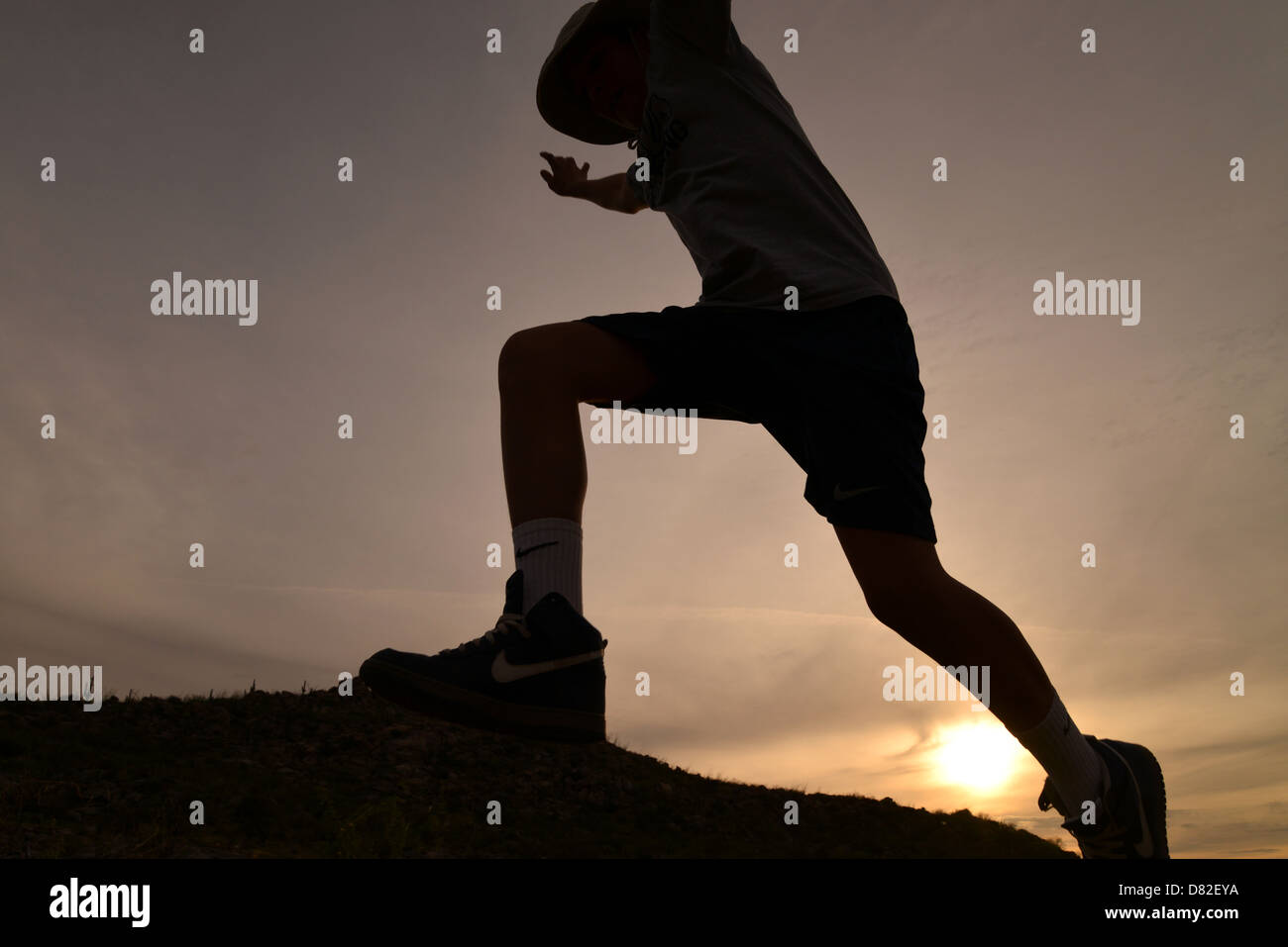 Boys jump boulders while hiking in the foothills of the Santa Catalina Mountains, Sonoran Desert
