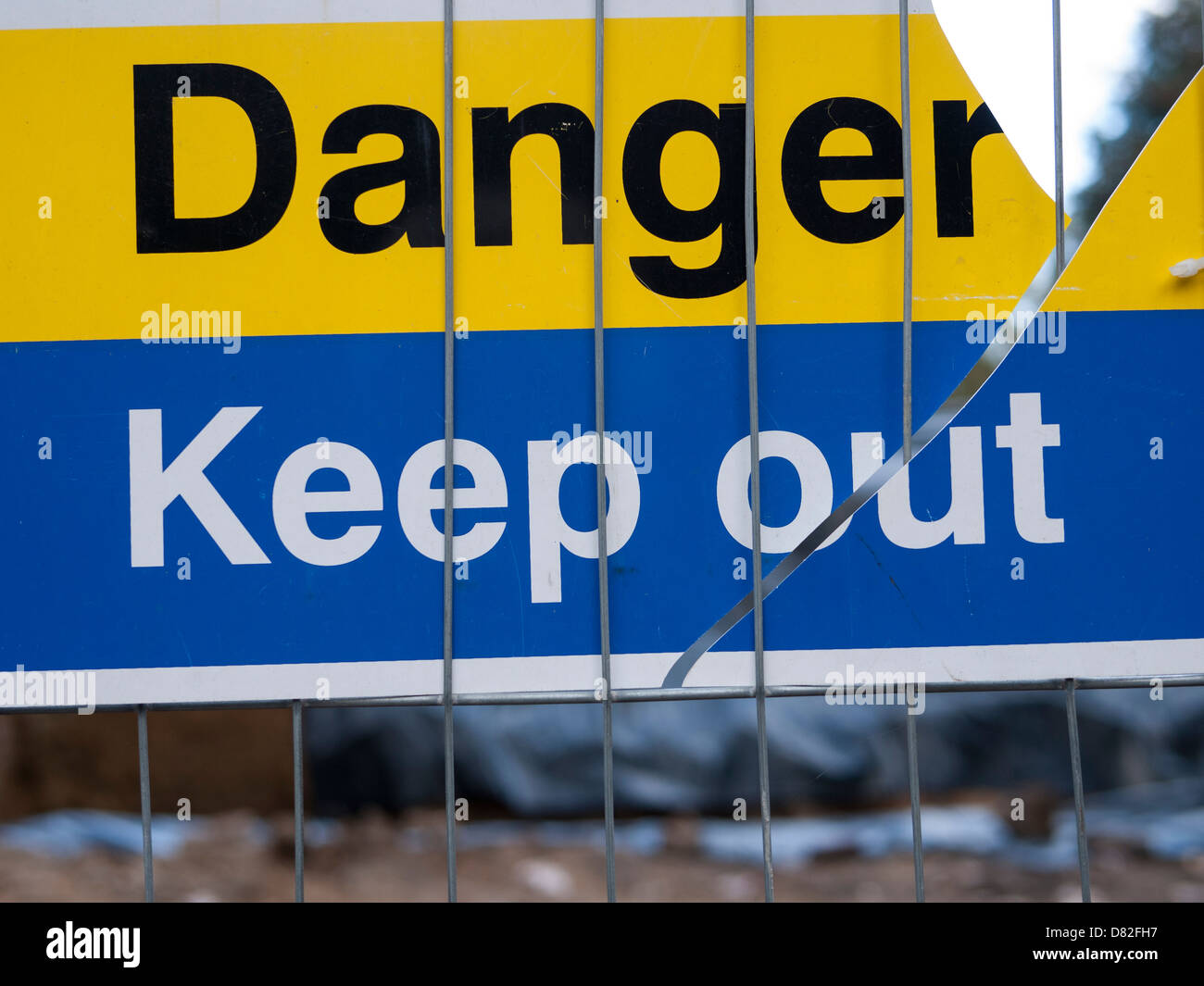 London, Yellow and blue Danger - Keep Out sign, close up photograph on building site Stock Photo