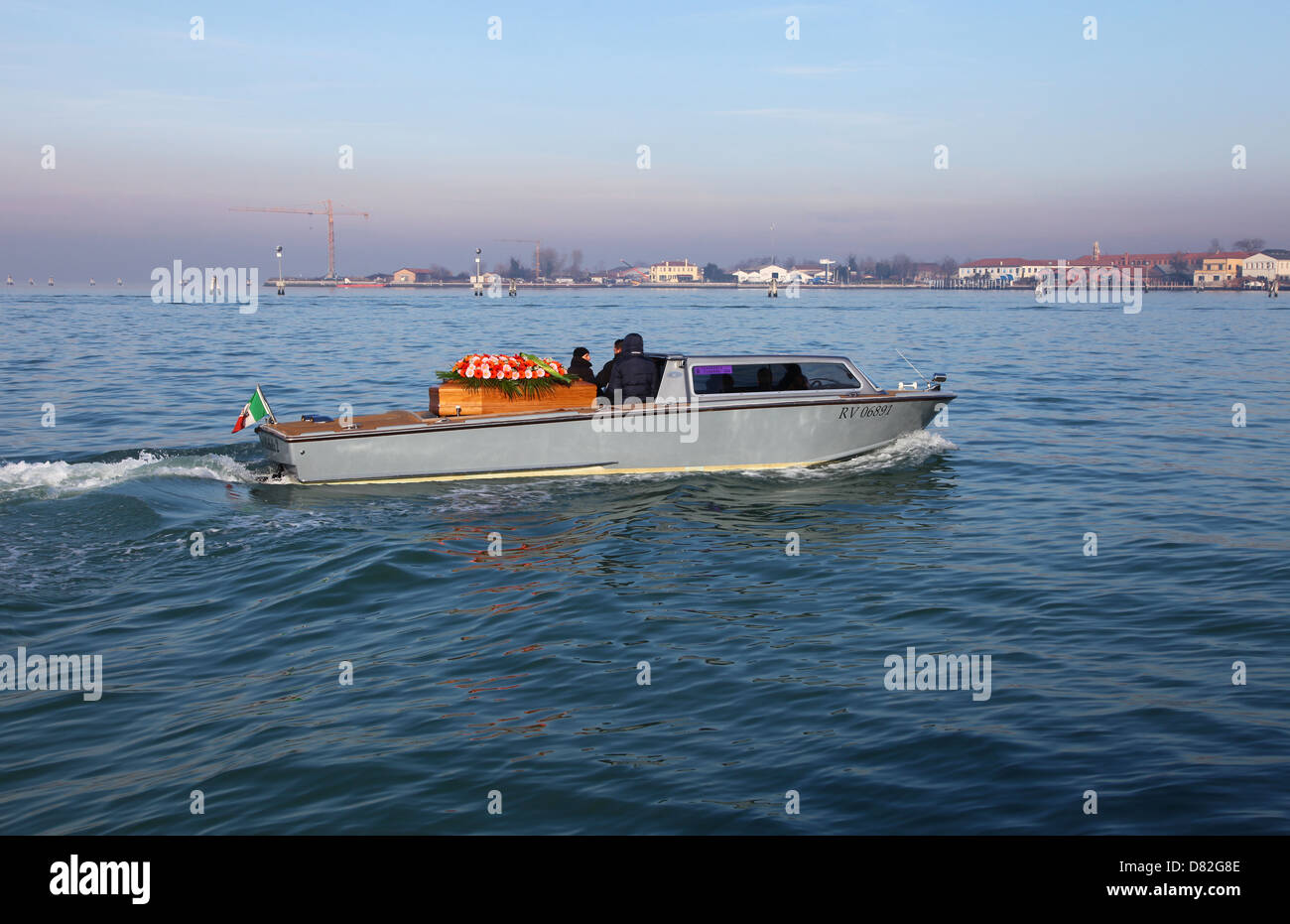 A coffin being carried by a boat on it's way to the cemetery on San Michele island Venice Italy Stock Photo