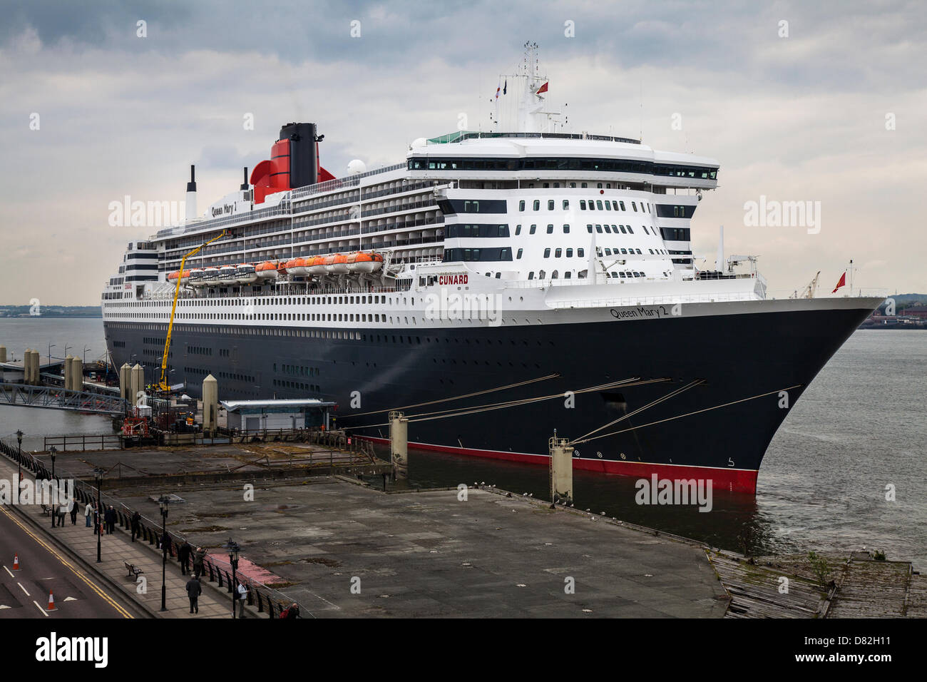 Liverpool, UK 17th May, 2013. The Big luxury Cruise Liner Terminal where the Passenger ship registered in Bermuda Liner RMS Queen Mary 2 berthed on her visit to the City.  The Liverpool Cruise Terminal is a 350-metre-long floating structure situated on the River Mersey enabling large cruise ships to visit without entering the enclosed dock system or berthing mid-river and tendering passengers ashore. The terminal was officially opened on 21 September 2007 by HRH The Duke of Kent when the Queen Elizabeth 2 berthed at the terminal. Stock Photo