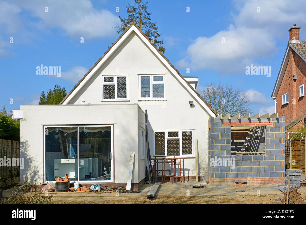 Building work to side of detached house to add two storey bedroom & kitchen extension seen from back garden England UK see 'More Info' note below Stock Photo