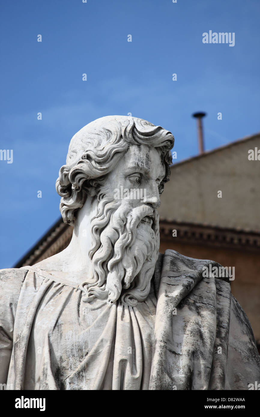 Statue of Saint Paul the Apostle with the chimney of Sistina Chapel on the background. Vatican City State Stock Photo