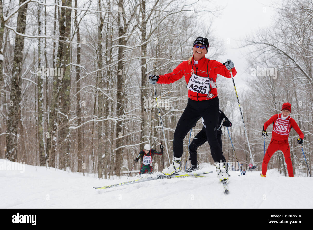 A competitor smiles while skiing on the  trail between Cable and Hayward, Wisconsin during the American Birkebeiner. Stock Photo