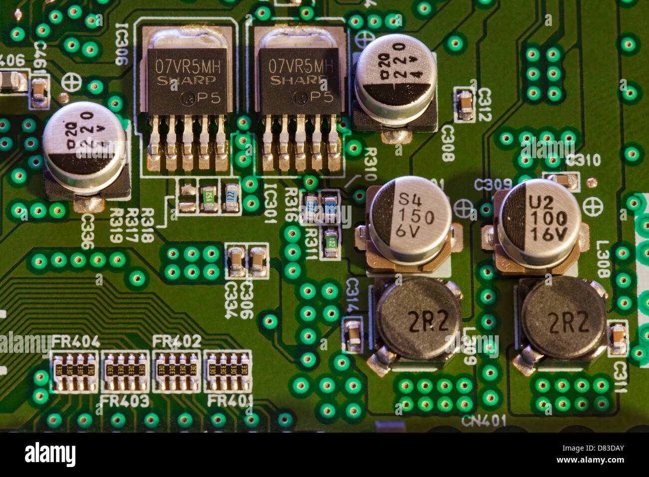Capacitors and transistors on circuit board Stock Photo