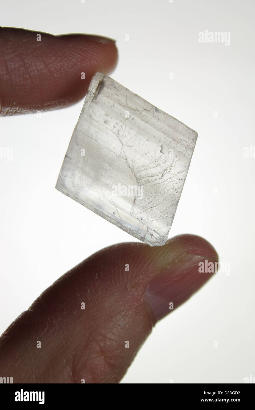 Clear Quartz Crystal Held Between Fingers Stock Photo
