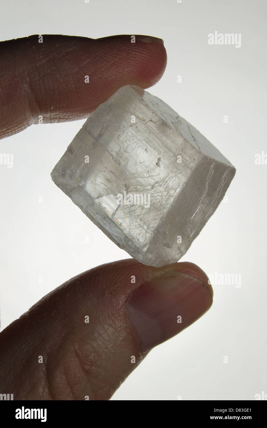 Clear Quartz Crystal Held Between Fingers Stock Photo