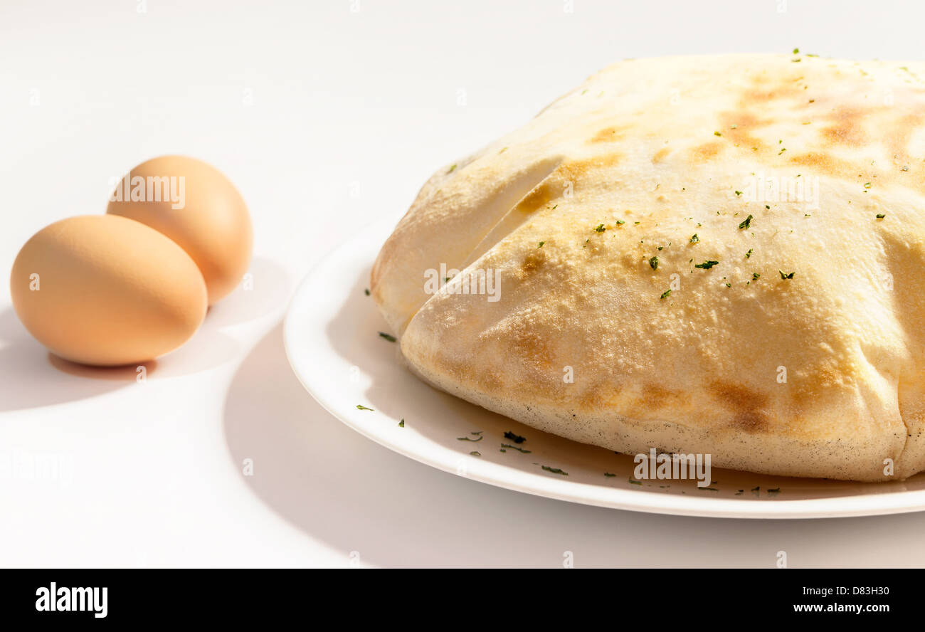 Bun on plate and two eggs Stock Photo - Alamy