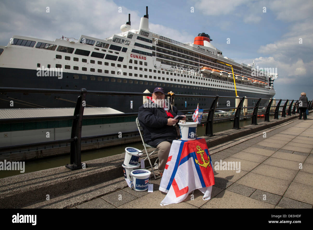 Liverpool, UK 17th May, 2013. Ray Roberts, from Edgehill collecting for RNLI Coastguard charity at the Cruise Liner Terminal where the Liner RMS Queen Mary 2 berthed on her visit to the City.  The Liverpool Cruise Terminal is a 350-metre-long floating structure situated on the River Mersey enabling large cruise ships to visit without entering the enclosed dock system or berthing mid-river and tendering passengers ashore. The terminal was officially opened on 21 September 2007 by HRH The Duke of Kent when the Queen Elizabeth 2 berthed at the terminal. Stock Photo