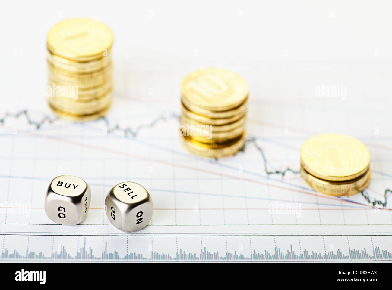 Dices cubes with the words SELL BUY and golden stack coins on financial chart downtrend. Selective focus Stock Photo