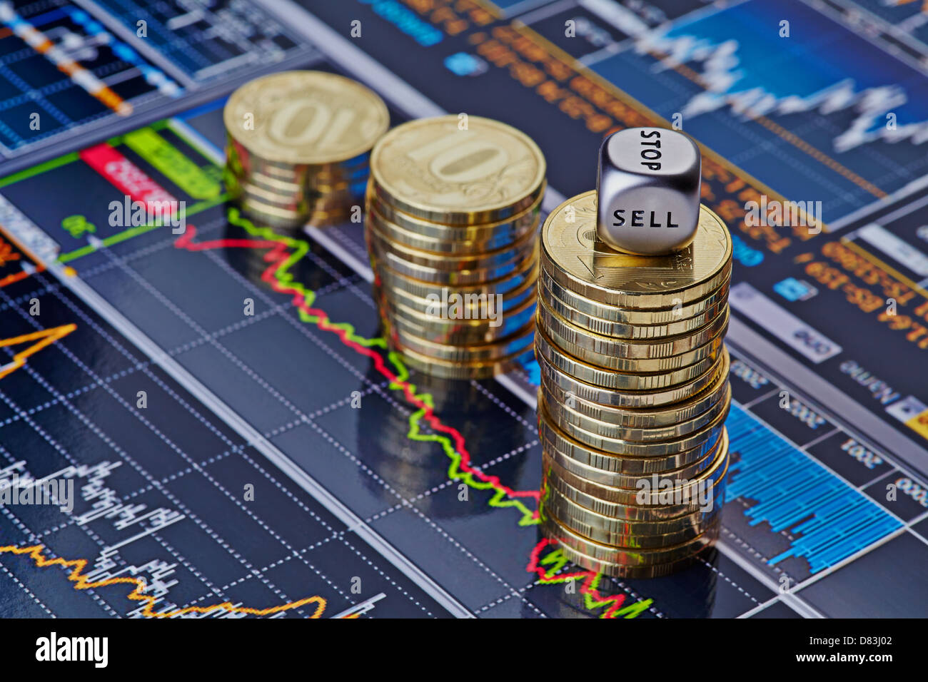 Uptrend stacks of golden coins and the dices cube with the word SELL. Financial chart as background. Selective focus Stock Photo