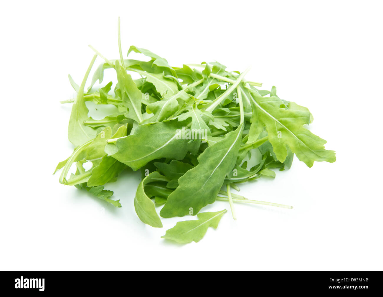 heap of rucola leaves isolated on white background Stock Photo