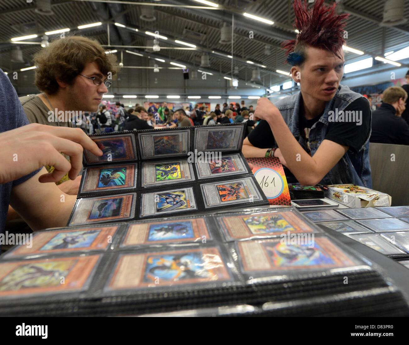 Participants of the German Yu-Gi-Oh! Trading Card Game Championships exchange strategy cards in Schkeuditz, Germany, 18 May 2013. More than 800 players competed against each other to win the title of German champion of the Japanese card game. The best 32 players achieved a qualification for the European Championships at the end of June i n Frankfurt (Main). Photo: Hendrik Schmidt/dpa Stock Photo
