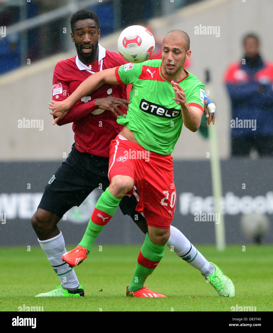 Hanover's Johan Djourou (L) vies for the ball with Duesseldorf's Dani Schahin during the Bundesliga soccer match between Hanover 96 and Fortuna Duesseldorf at AWD Arena in Hanover, Germany, 18 May 2013. Photo: PETER STEFFEN (ATTENTION: EMBARGO CONDITIONS! The DFL permits the further utilisation of up to 15 pictures only (no sequntial pictures or video-similar series of pictures allowed) via the internet and online media during the match (including halftime), taken from inside the stadium and/or prior to the start of the match. The DFL permits the unrestricted transmission of digitised recordin Stock Photo