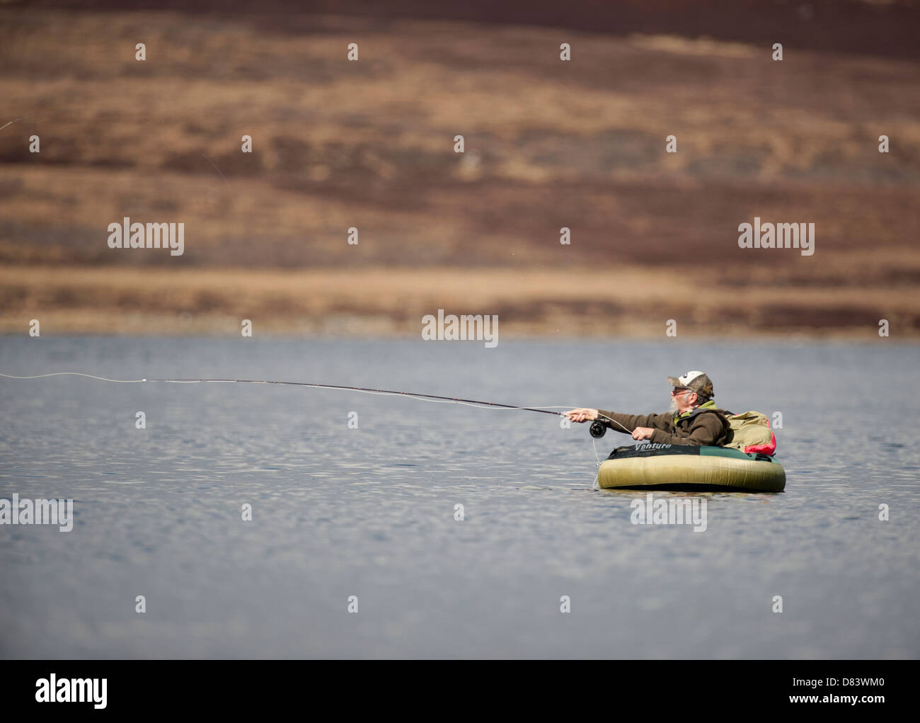 Fisherman floating on a Scottish Loch using a float tube. SCO 9129
