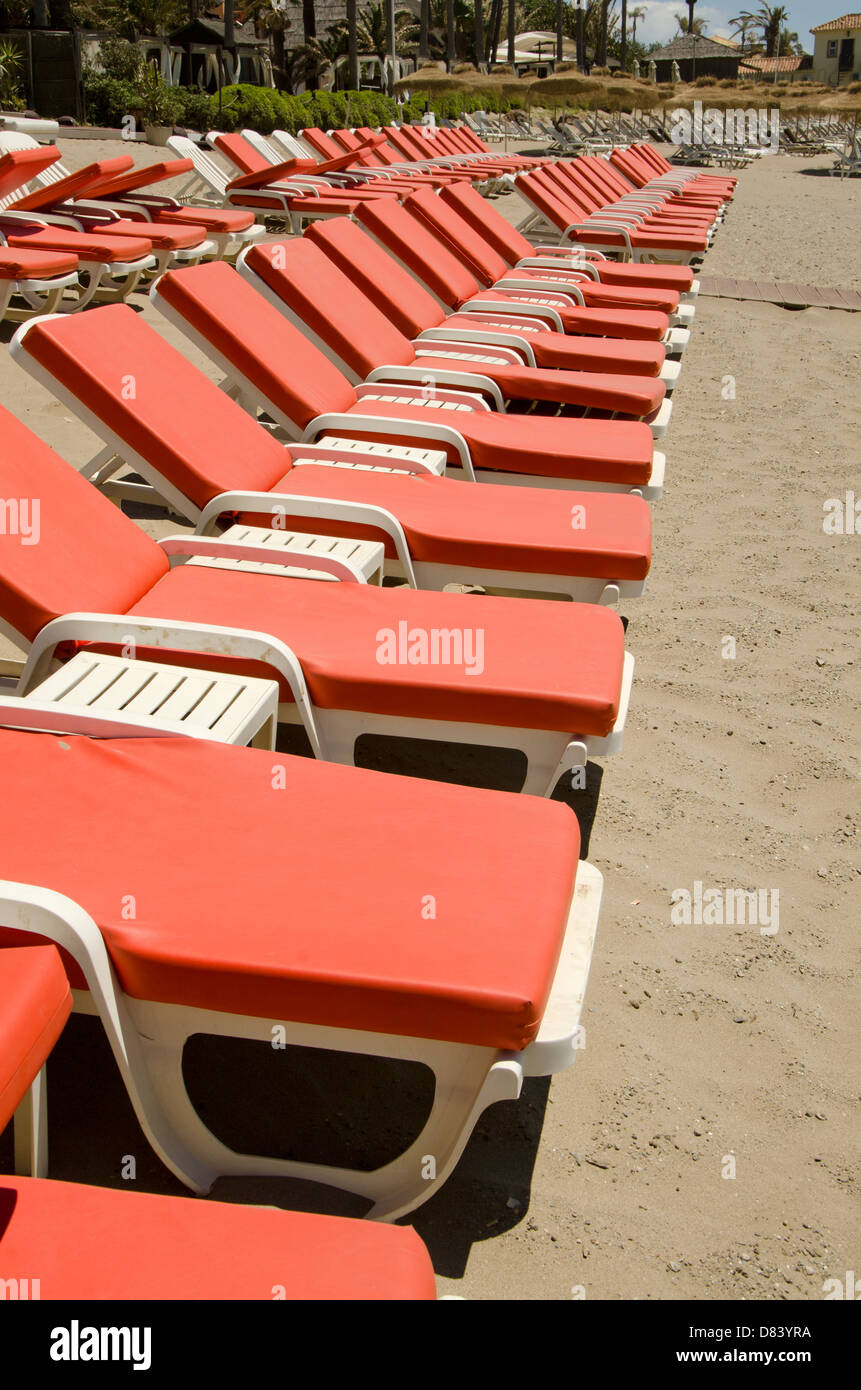Nikki Beach luxury beach club in Marbella with empty red sunbeds, Costa