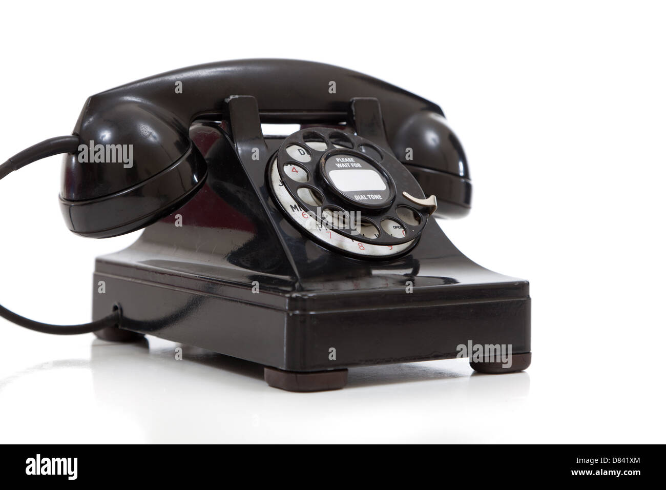 A vintage black rotary phone on a white background Stock Photo