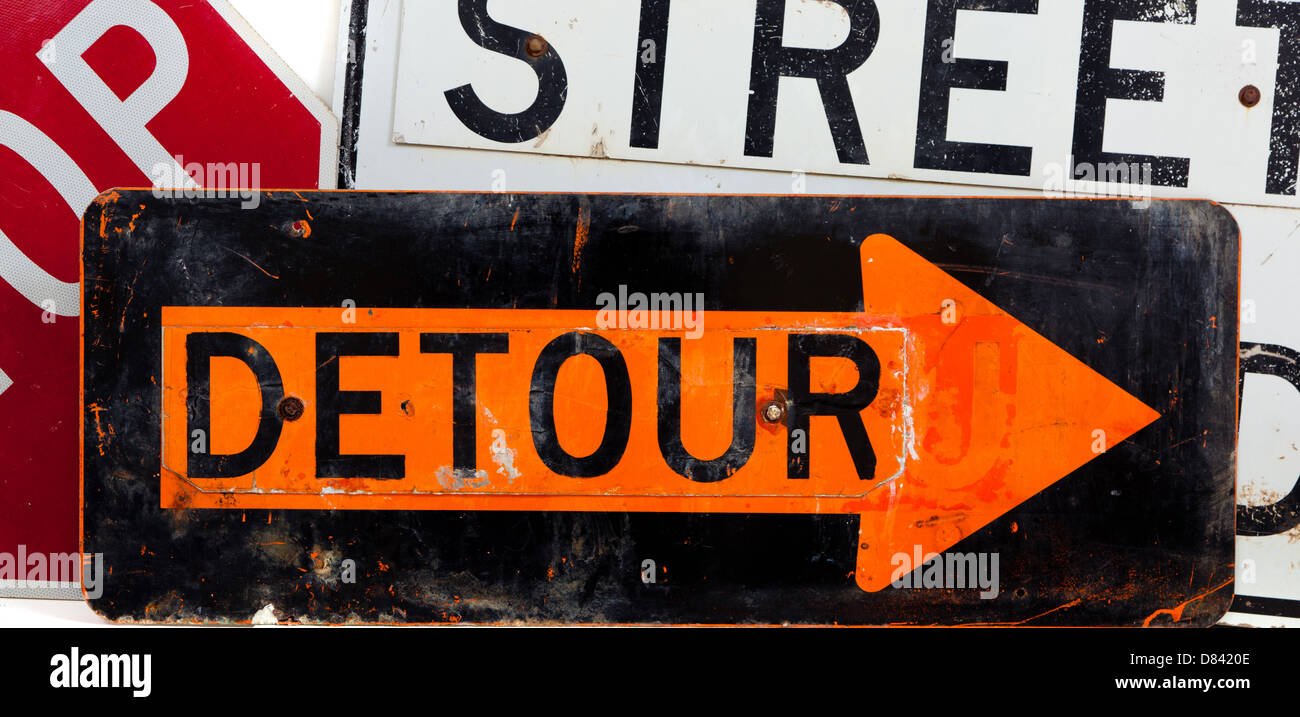 Assorted road signs including a detour sign, stop sign and a street closed sign on a white background Stock Photo
